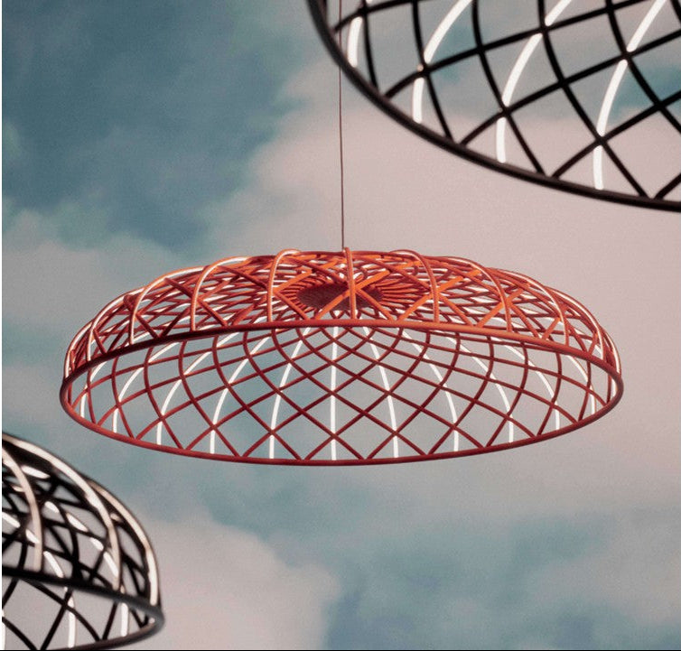Red wireframe pendant light against a cloudy sky background